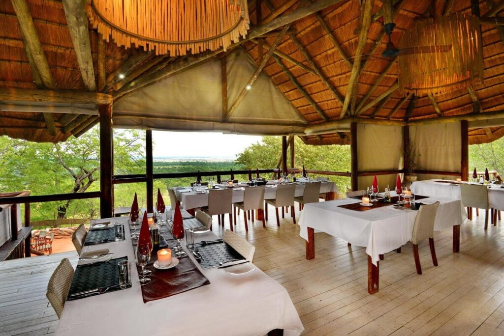 Open-air dining area at Ghoha Hills Savuti Lodge with wide views over Chobe National Park.