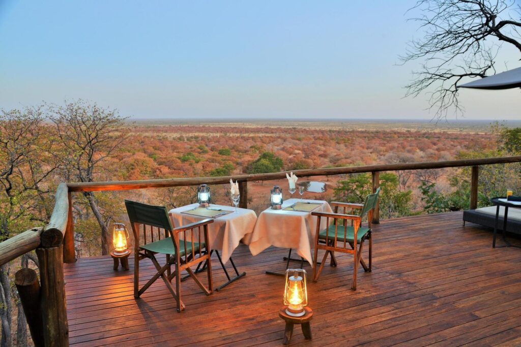 Outdoor dining deck at Ghoha Hills Savuti Lodge with panoramic views of the Savuti plains.