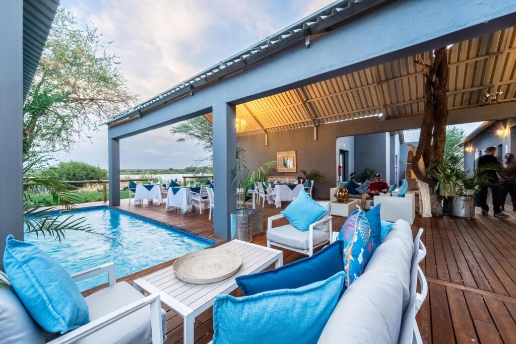 Outdoor pool and lounge deck at Lenyebi River Lodge overlooking the Chobe River