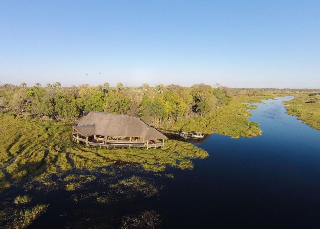 Aerial view of Moremi Crossing Camp surrounded by waterways and lush vegetation in the Okavango Delta, Botswana