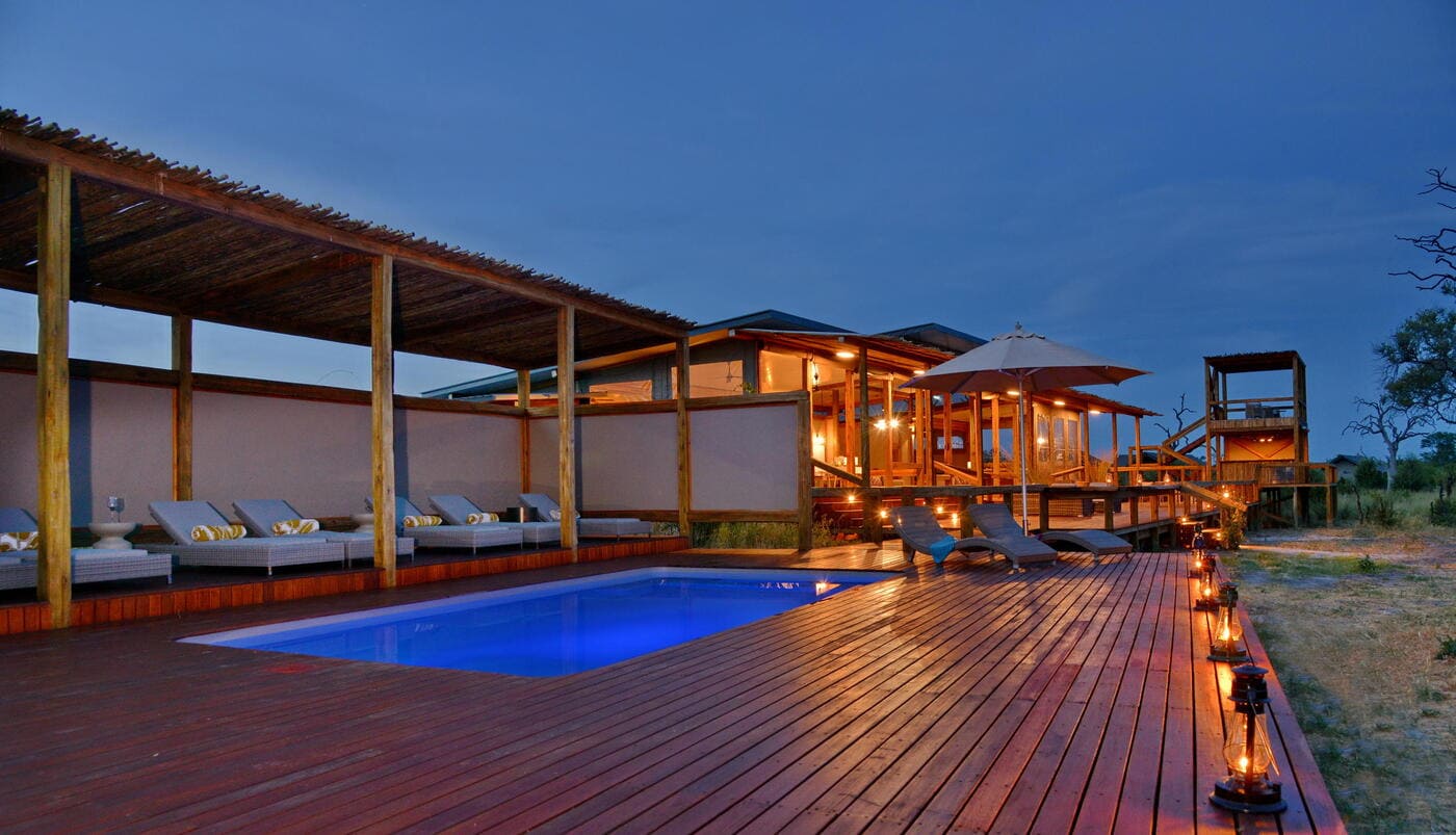 Pool and lounge deck at Nogatsaa Pans Lodge overlooking the remote Chobe landscape.
