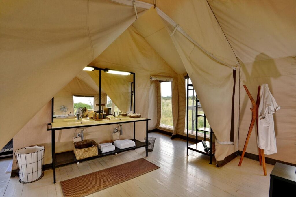 Luxury tented suite bathroom at Nogatsaa Pans Lodge in Chobe National Park.