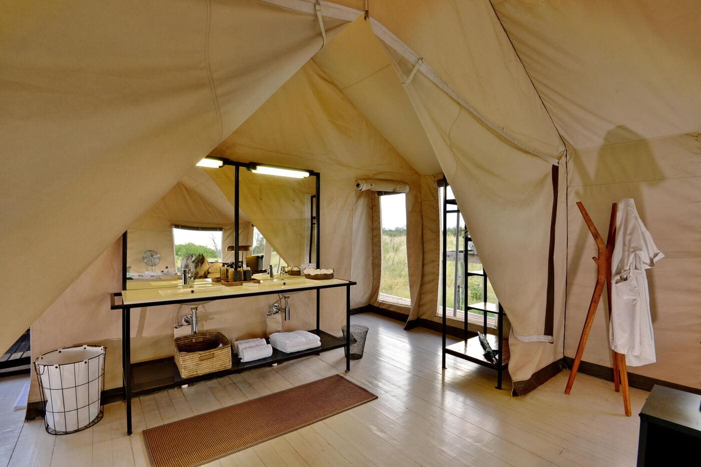Luxury tented suite bathroom at Nogatsaa Pans Lodge in Chobe National Park.