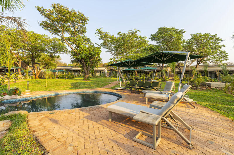 Swimming pool and outdoor loungers at Waterfalls Lodge