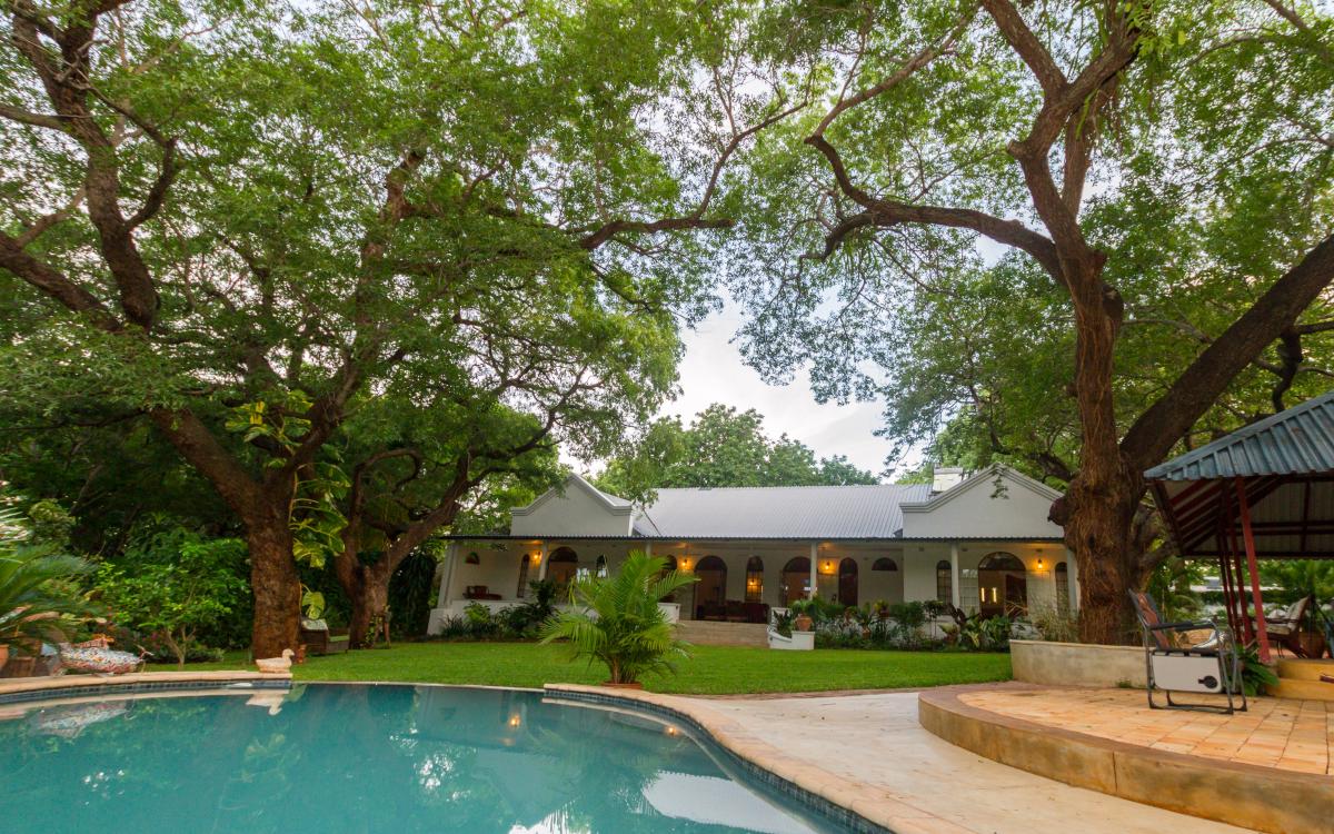 Swimming pool and terrace at The Courtney Lodge in Zimbabwe